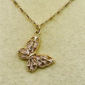 Rhinestone Butterfly Pendant on a Delicate Gold Tone Necklace. 16 inches
